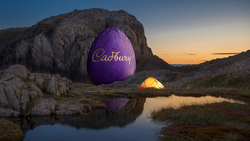 giant Cadbury egg in a highland landscape